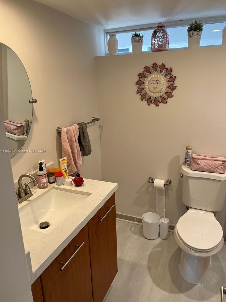 650 Northeast 64th Street, Unit G508 Miami, FL 33138 - Photo 9 of 11 a bathroom with a sink mirror vanity and toilet