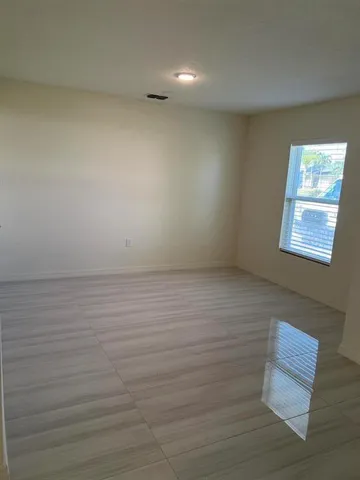 a view of an empty room with a window