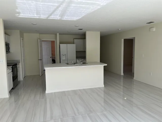 a view living room with stainless steel appliances kitchen island