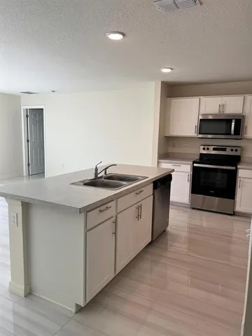 a kitchen with stainless steel appliances granite countertop a sink and stove top oven