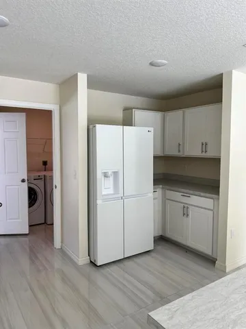 a kitchen with cabinets stainless steel appliances and a counter space