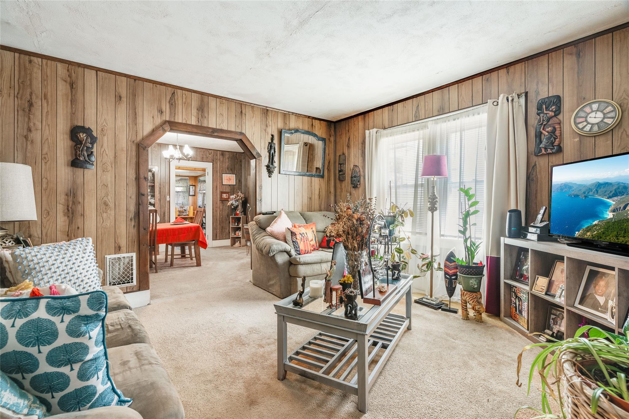 17 Lawrence Road Poughkeepsie, NY 12601 - Photo 7 of 17 Living area featuring visible vents, wood walls, carpet, and arched walkways