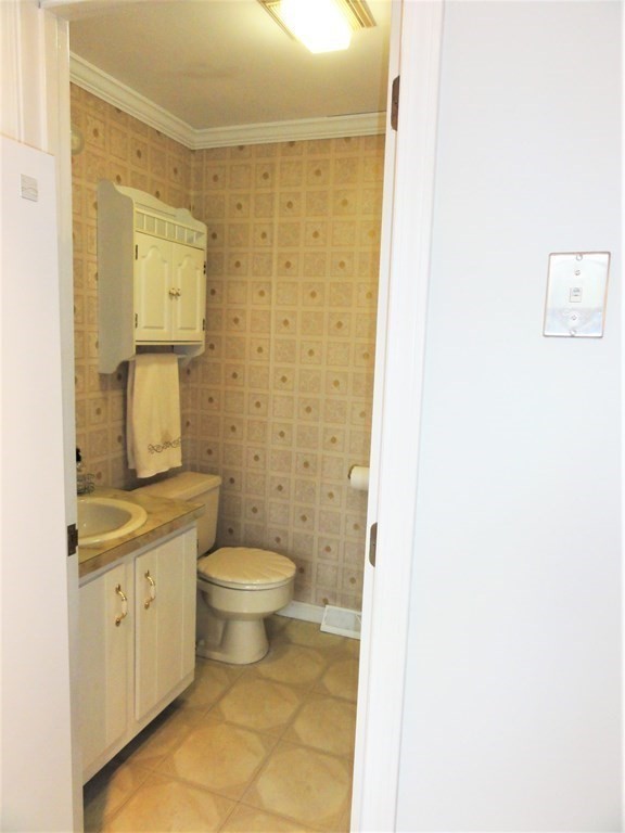 1955 Middlesex Street, Unit E Lowell, MA 01851 - Photo 8 of 20 a bathroom with a sink a toilet and shower