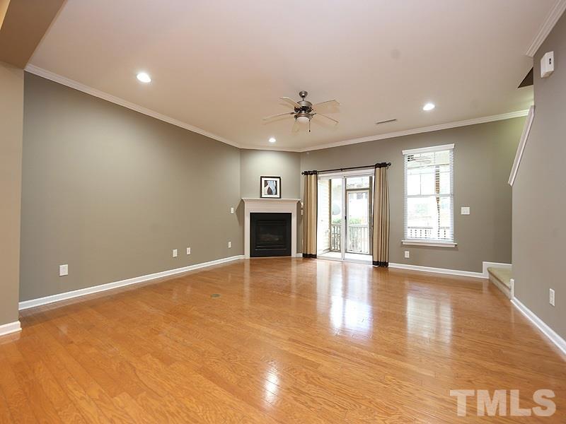 2405 Swans Rest Way, Unit 86 Raleigh, NC 27606 - Photo 4 of 12 a view of an empty room with a fireplace and a window