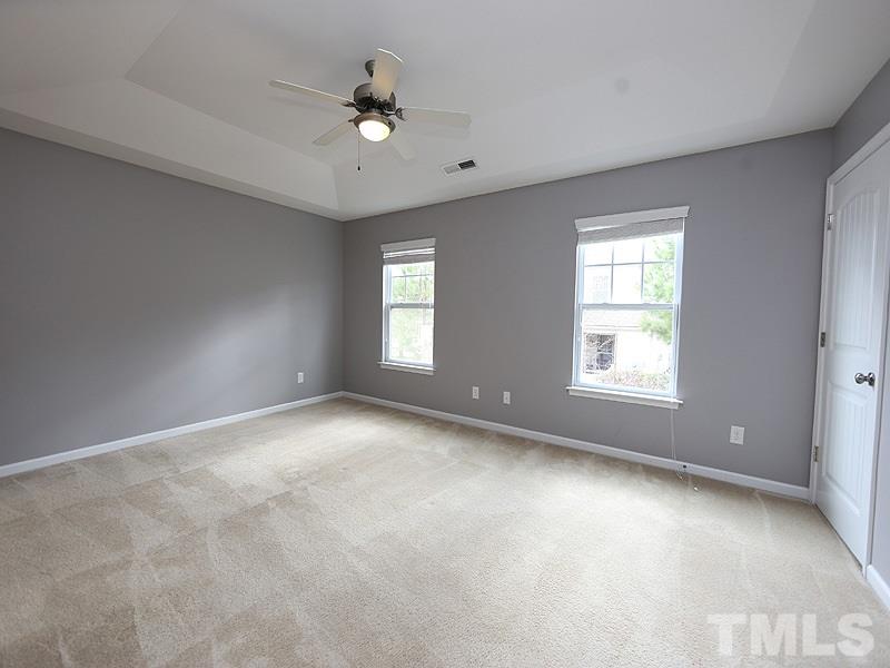 2405 Swans Rest Way, Unit 86 Raleigh, NC 27606 - Photo 5 of 12 an empty room with windows and fan