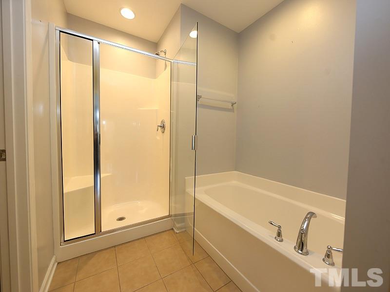 2405 Swans Rest Way, Unit 86 Raleigh, NC 27606 - Photo 6 of 12 a bathroom with a bathtub and a shower