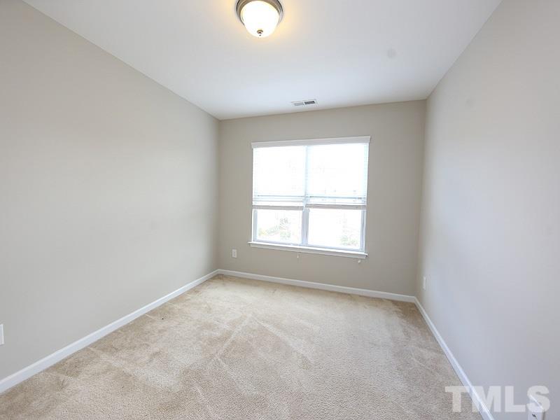 2405 Swans Rest Way, Unit 86 Raleigh, NC 27606 - Photo 7 of 12 an empty room with a window