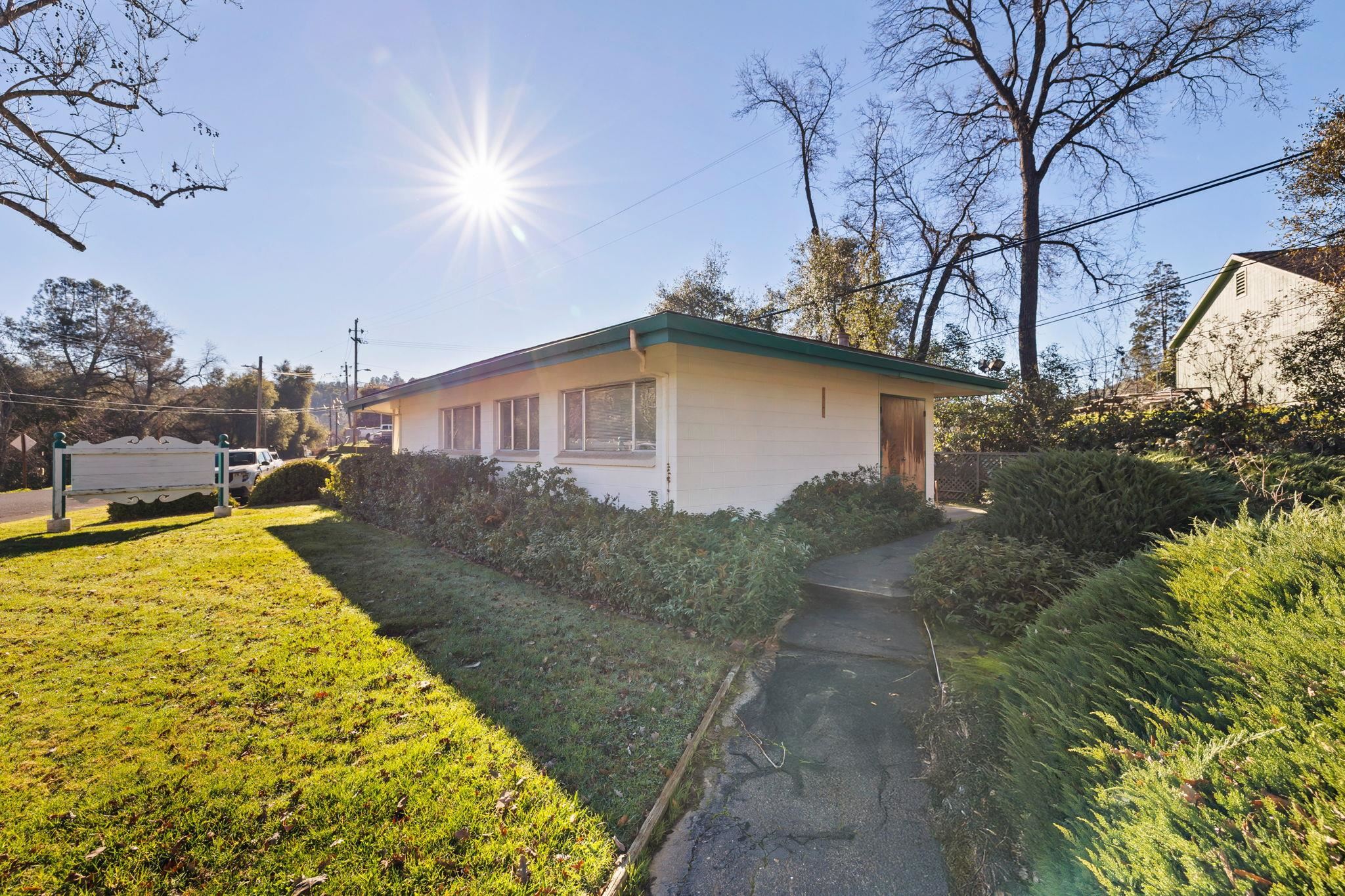 6 South Forrest Sonora, CA 95370 - Photo 3 of 17 View of property exterior with a yard and concrete block siding