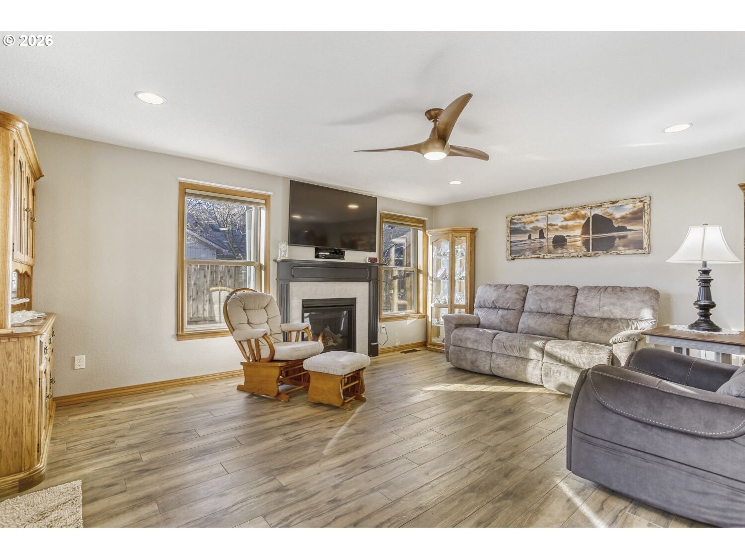 357 Southeast 7th Avenue Canby, OR 97013 - Photo 12 of 29 a living room with furniture a fireplace and a flat screen tv