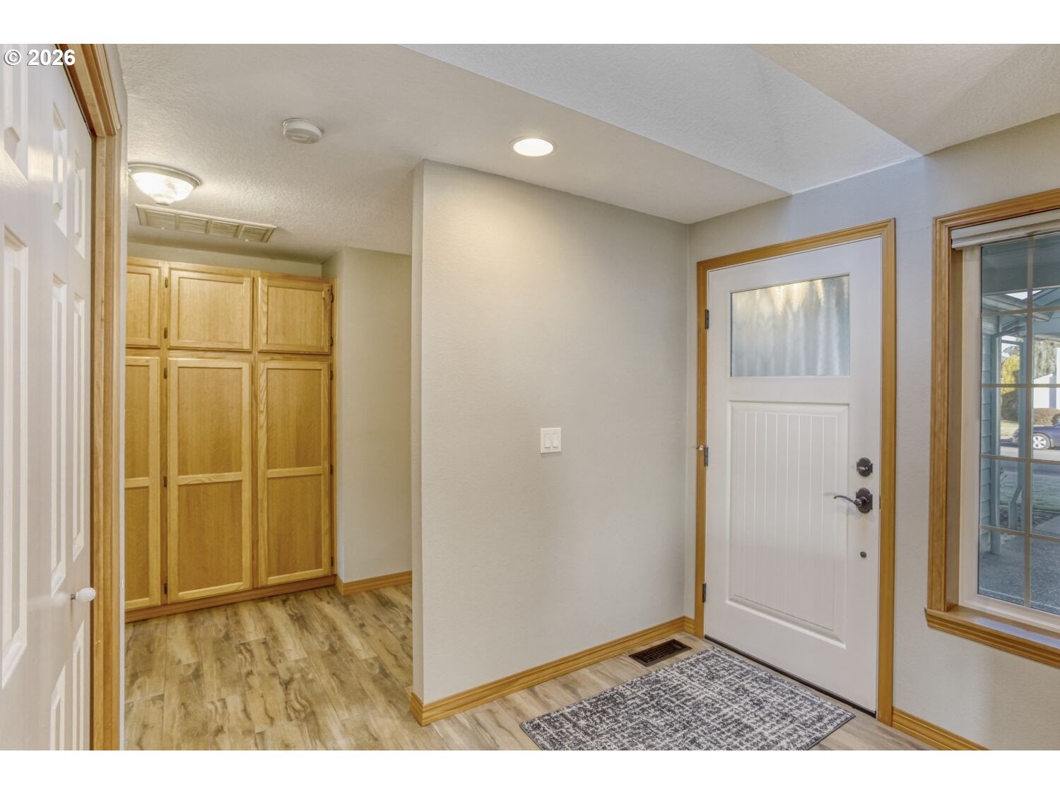 357 Southeast 7th Avenue Canby, OR 97013 - Photo 6 of 29 a view of an empty room with window and door