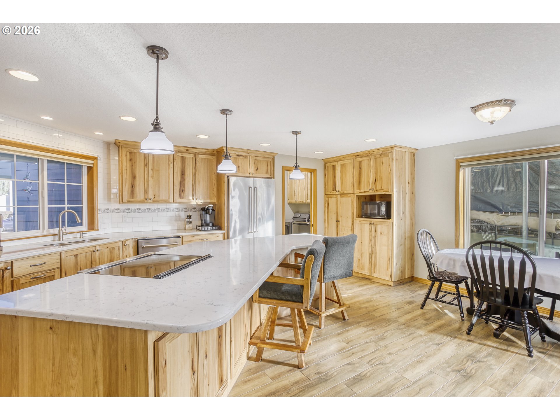 357 Southeast 7th Avenue Canby, OR 97013 - Photo 8 of 29 a kitchen with a table chairs and flat screen tv
