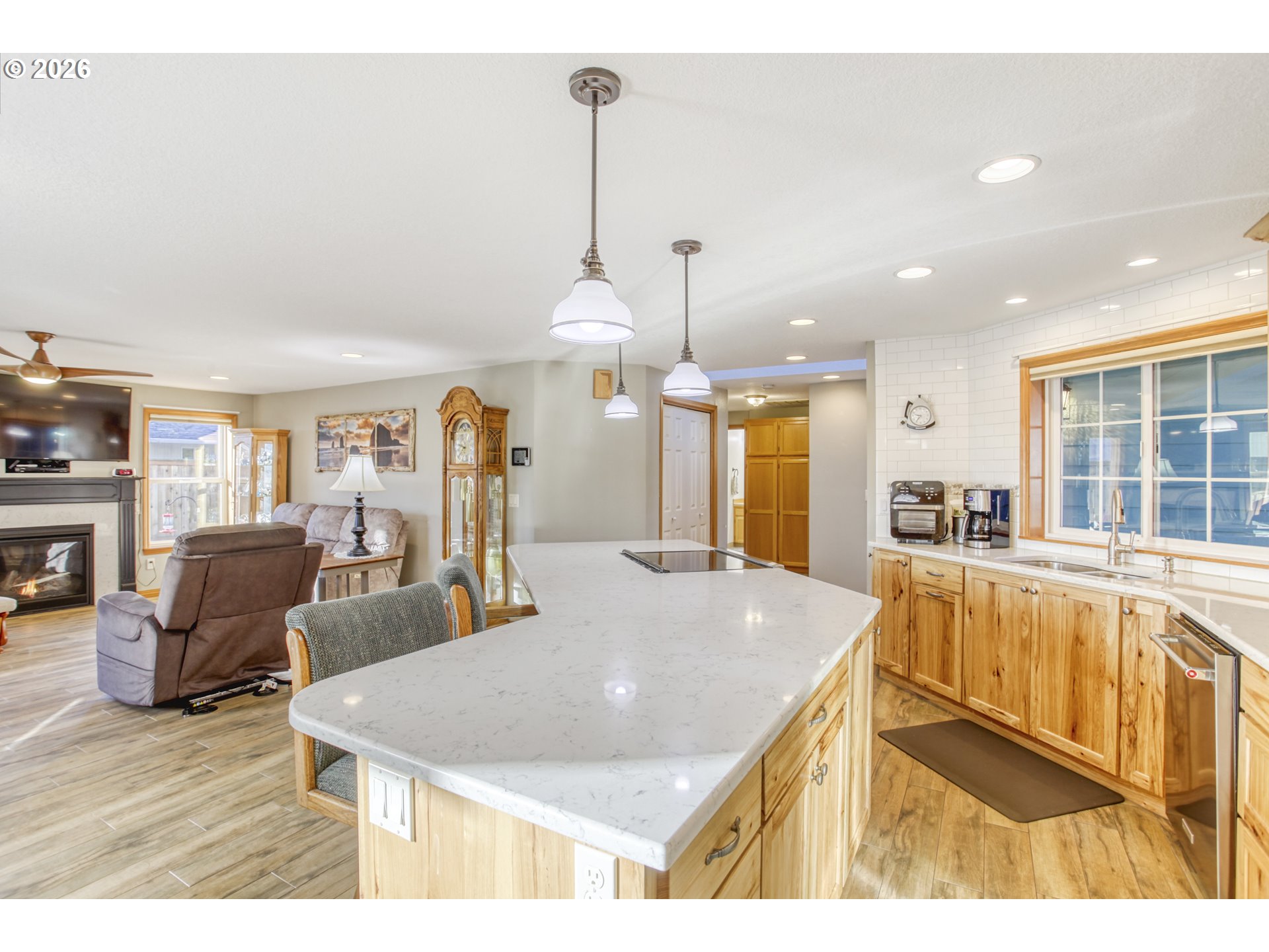 357 Southeast 7th Avenue Canby, OR 97013 - Photo 9 of 29 a open kitchen with stainless steel appliances kitchen island granite countertop a refrigerator a sink a dining table and chairs with wooden floor