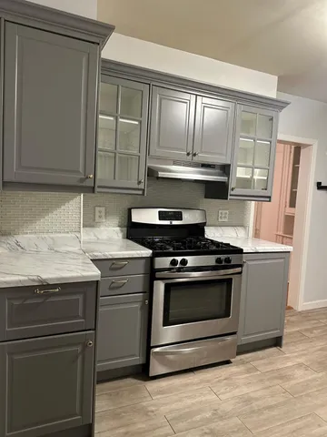 a kitchen with granite countertop stainless steel appliances and wooden cabinets
