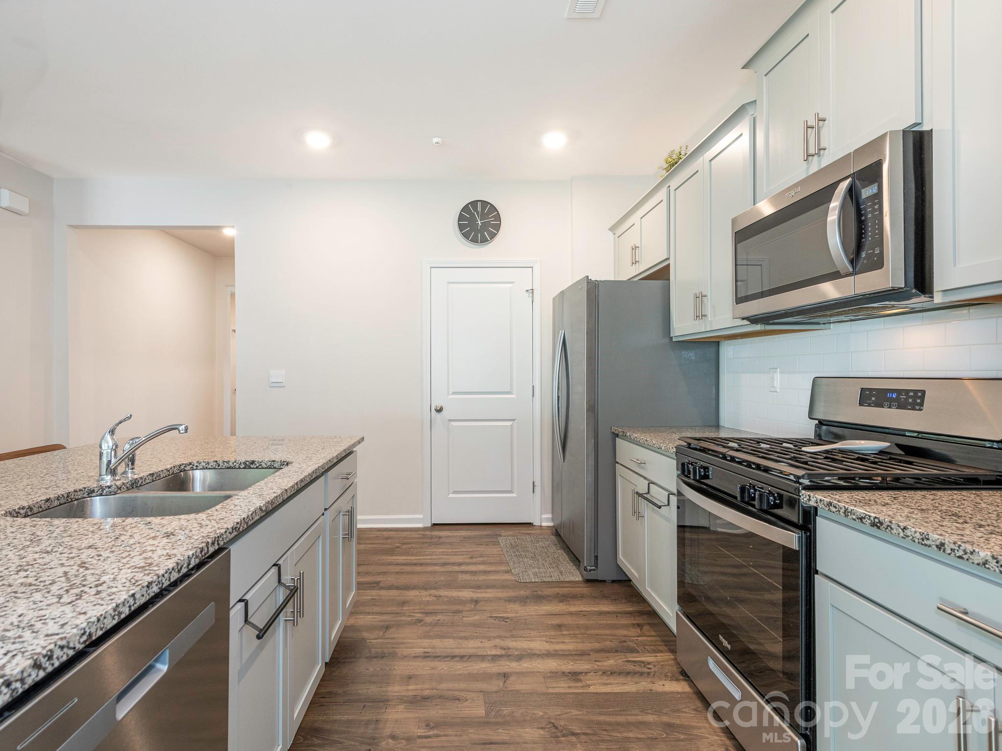 3649 Azalea Rdg Drive Mount Holly, NC 28120 - Photo 24 of 37 a kitchen with stainless steel appliances granite countertop a sink stove and refrigerator