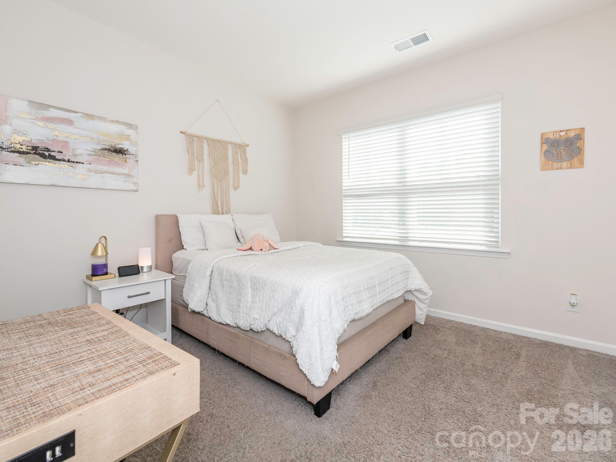 3649 Azalea Rdg Drive Mount Holly, NC 28120 - Photo 5 of 37 a large bed sitting in a bedroom next to a window