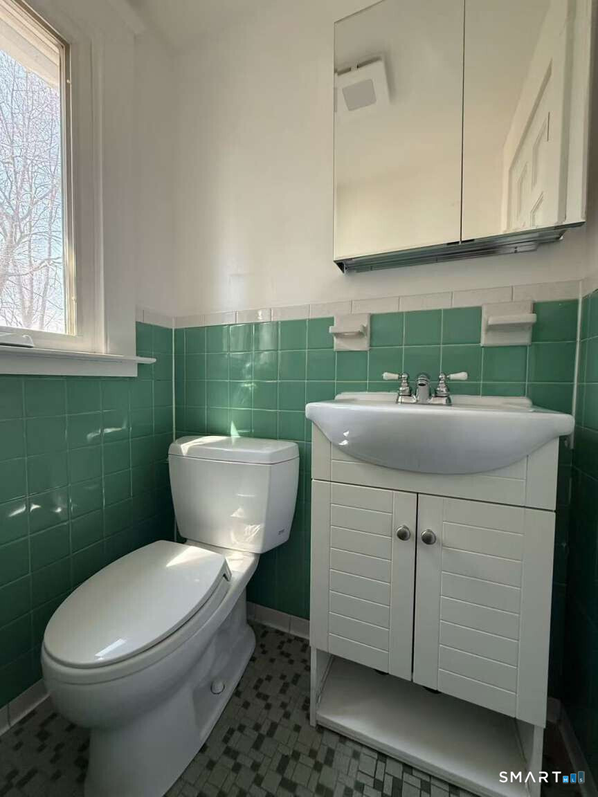 24 Paramount Avenue Hamden, CT 06517 - Photo 12 of 25 a bathroom with a sink mirror and toilet