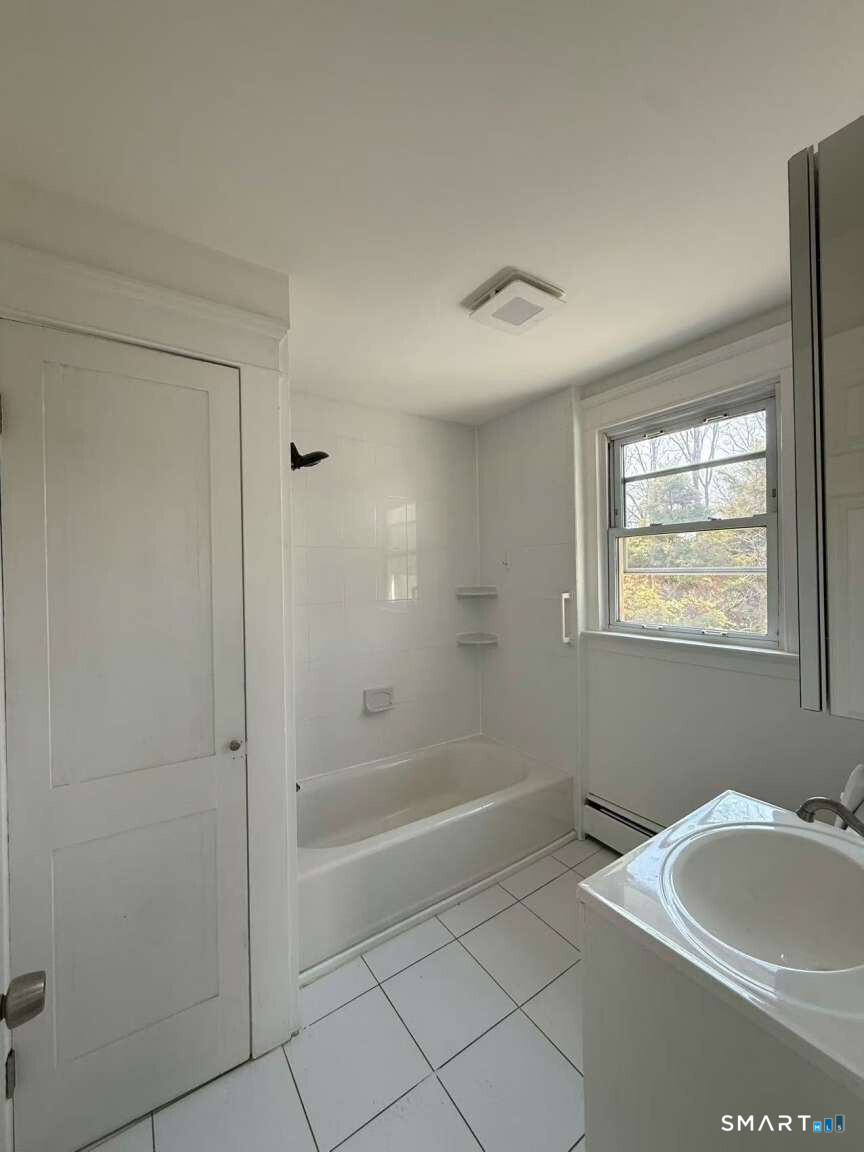 24 Paramount Avenue Hamden, CT 06517 - Photo 14 of 25 a bathroom with a bathtub and a sink