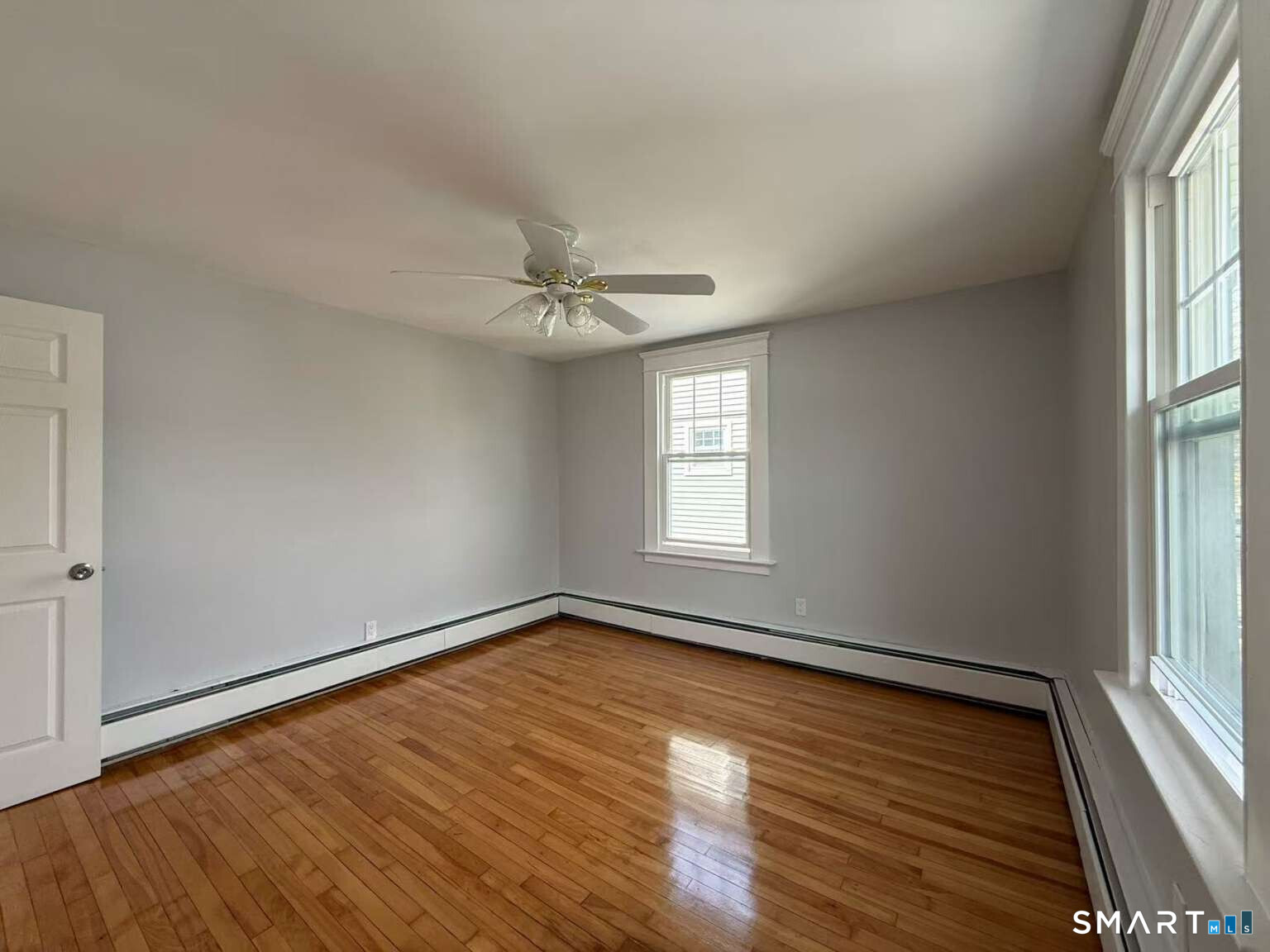 24 Paramount Avenue Hamden, CT 06517 - Photo 17 of 25 a view of an empty room with wooden floor and a window