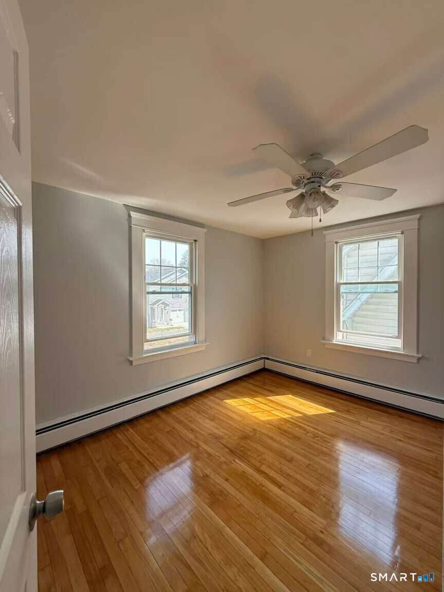24 Paramount Avenue Hamden, CT 06517 - Photo 18 of 25 wooden floor in an empty room with a window