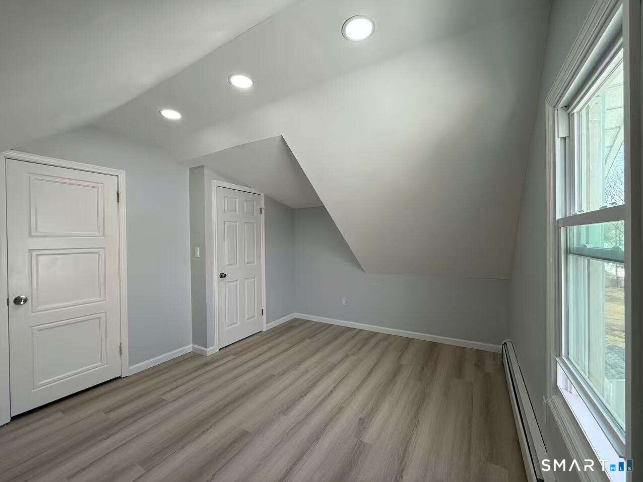 24 Paramount Avenue Hamden, CT 06517 - Photo 20 of 25 an empty room with wooden floor and windows