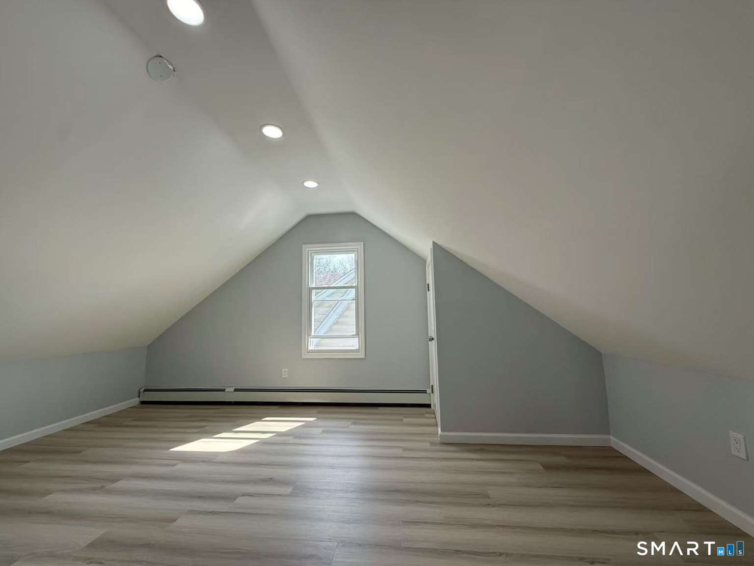 24 Paramount Avenue Hamden, CT 06517 - Photo 21 of 25 an empty room with wooden floor and windows