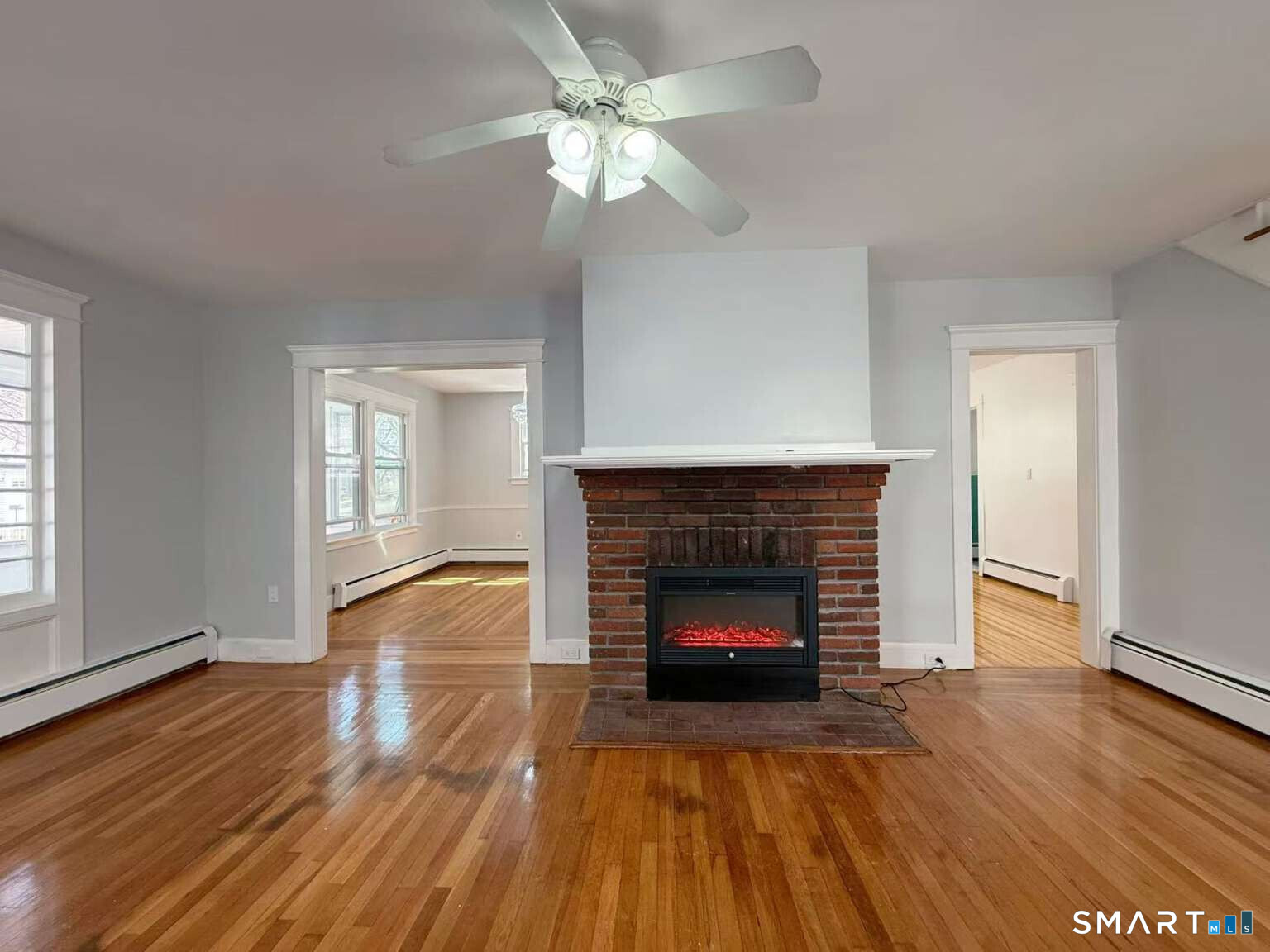 24 Paramount Avenue Hamden, CT 06517 - Photo 5 of 25 a living room with a fireplace and wooden floor