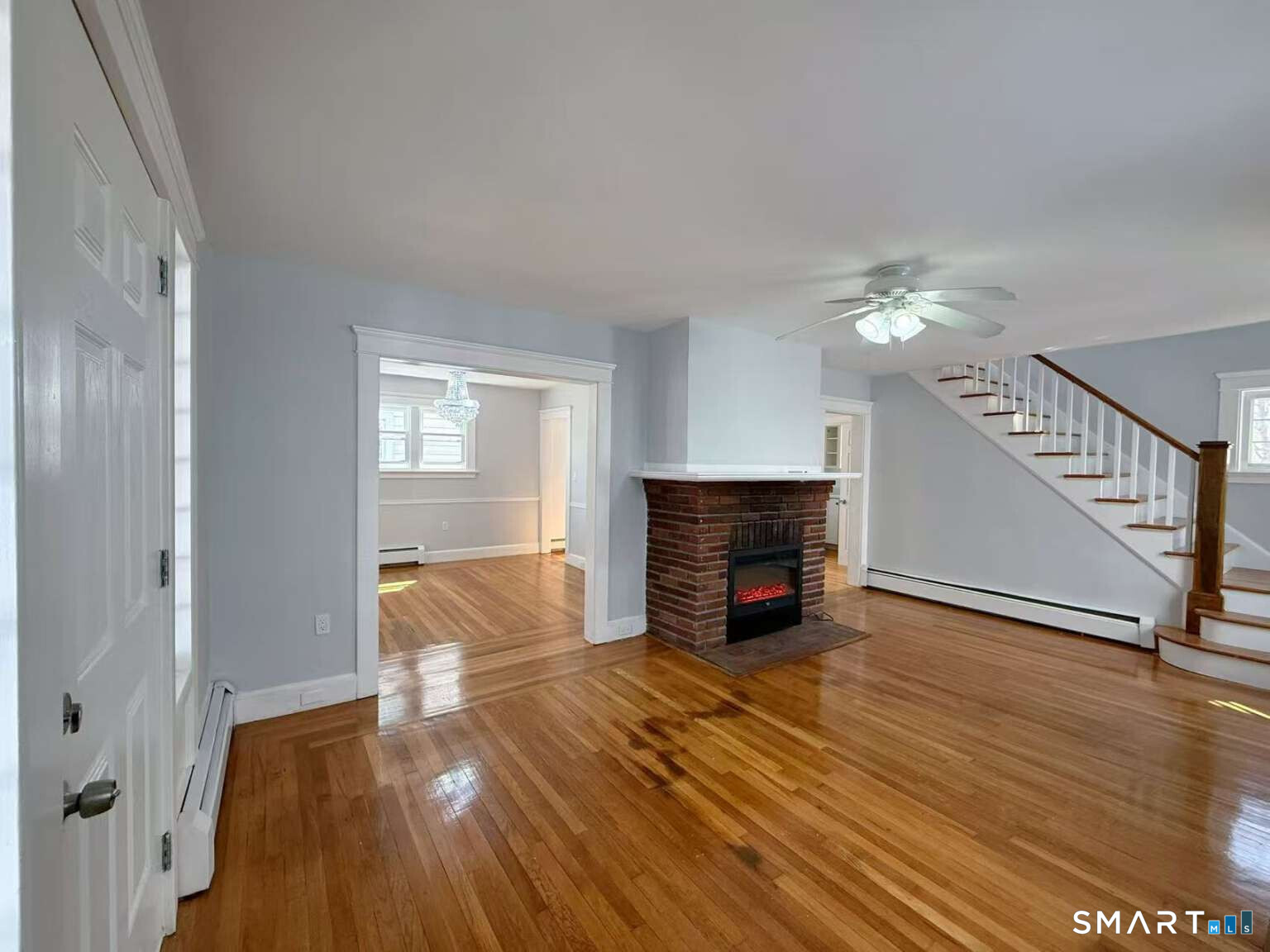 24 Paramount Avenue Hamden, CT 06517 - Photo 6 of 25 a view of empty room with wooden floor and fireplace