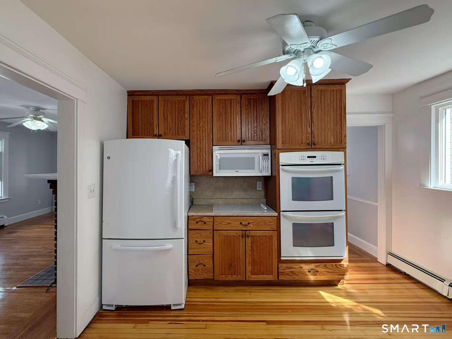 24 Paramount Avenue Hamden, CT 06517 - Photo 9 of 25 a kitchen with kitchen island granite countertop a stove a refrigerator and a sink with wooden floor
