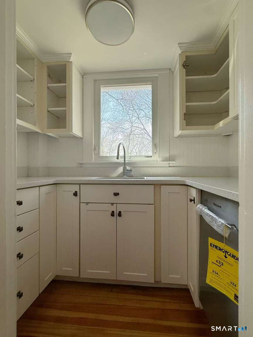 24 Paramount Avenue Hamden, CT 06517 - Photo 10 of 25 a kitchen with a sink cabinets and a window