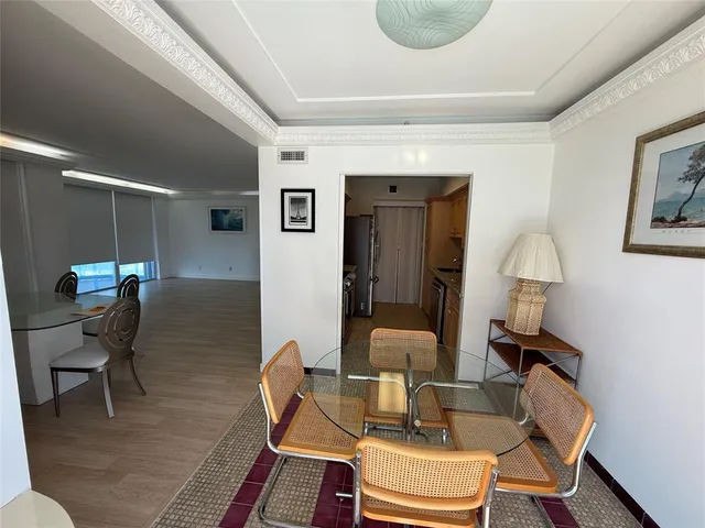 a kitchen with granite countertop a sink stove and refrigerator