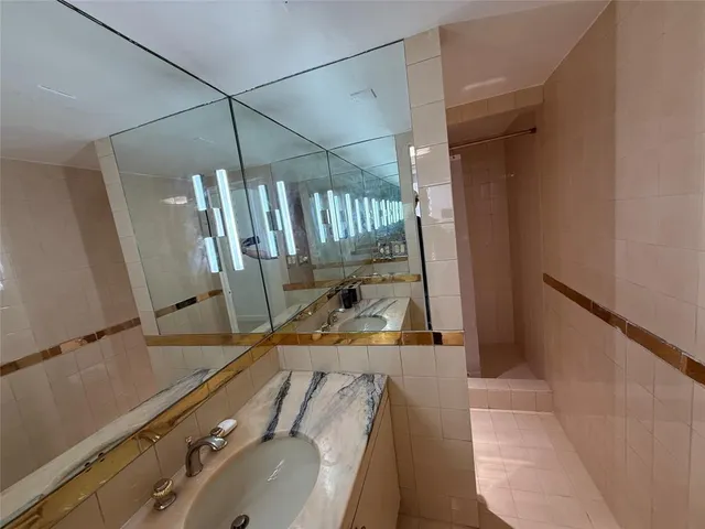 a view of an empty room with wooden floor and window