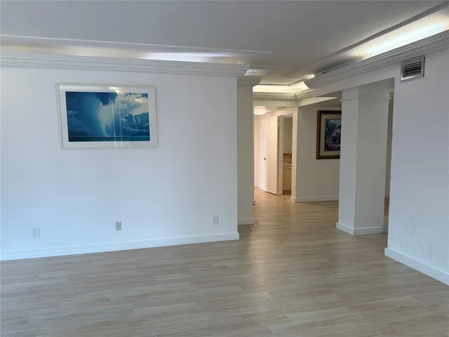a view of a livingroom with furniture and an empty room
