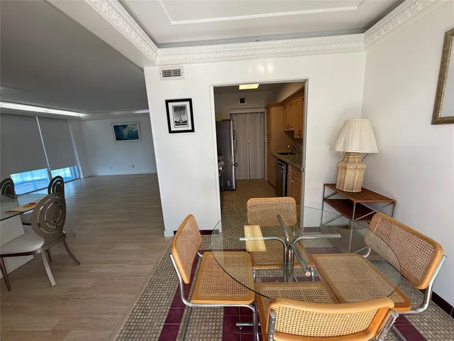 a dining room with furniture and a mirror