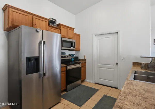 a view of kitchen with sink and refrigerator