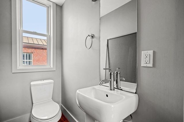 a bathroom with a sink a toilet and a mirror