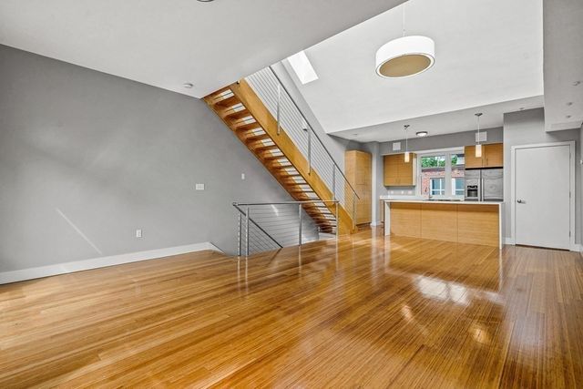 a view of a room with wooden floor