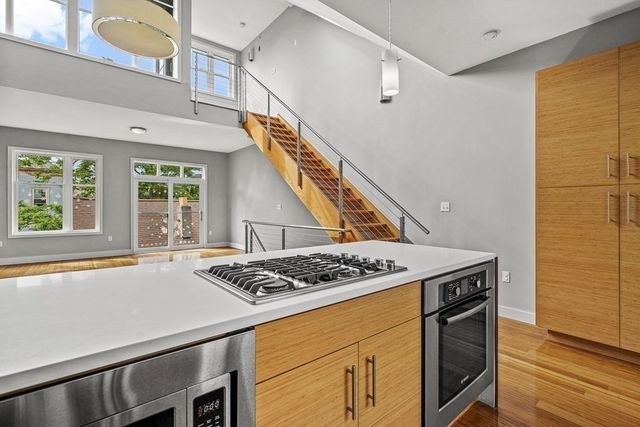 a kitchen that has a stove and a table in it
