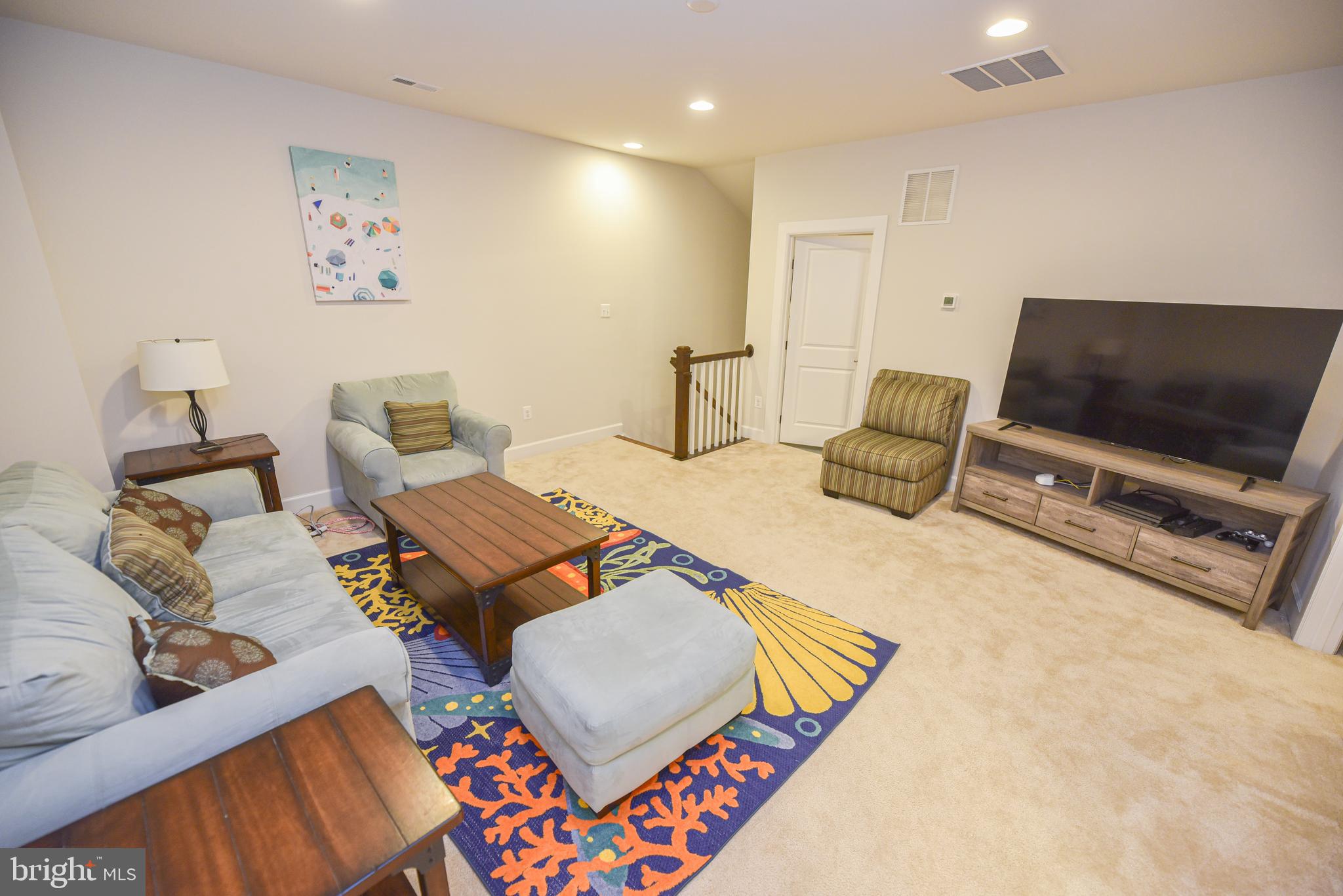 22379 Grebe Lane Ocean View, DE 19970 - Photo 24 of 41 a living room with furniture and a flat screen tv