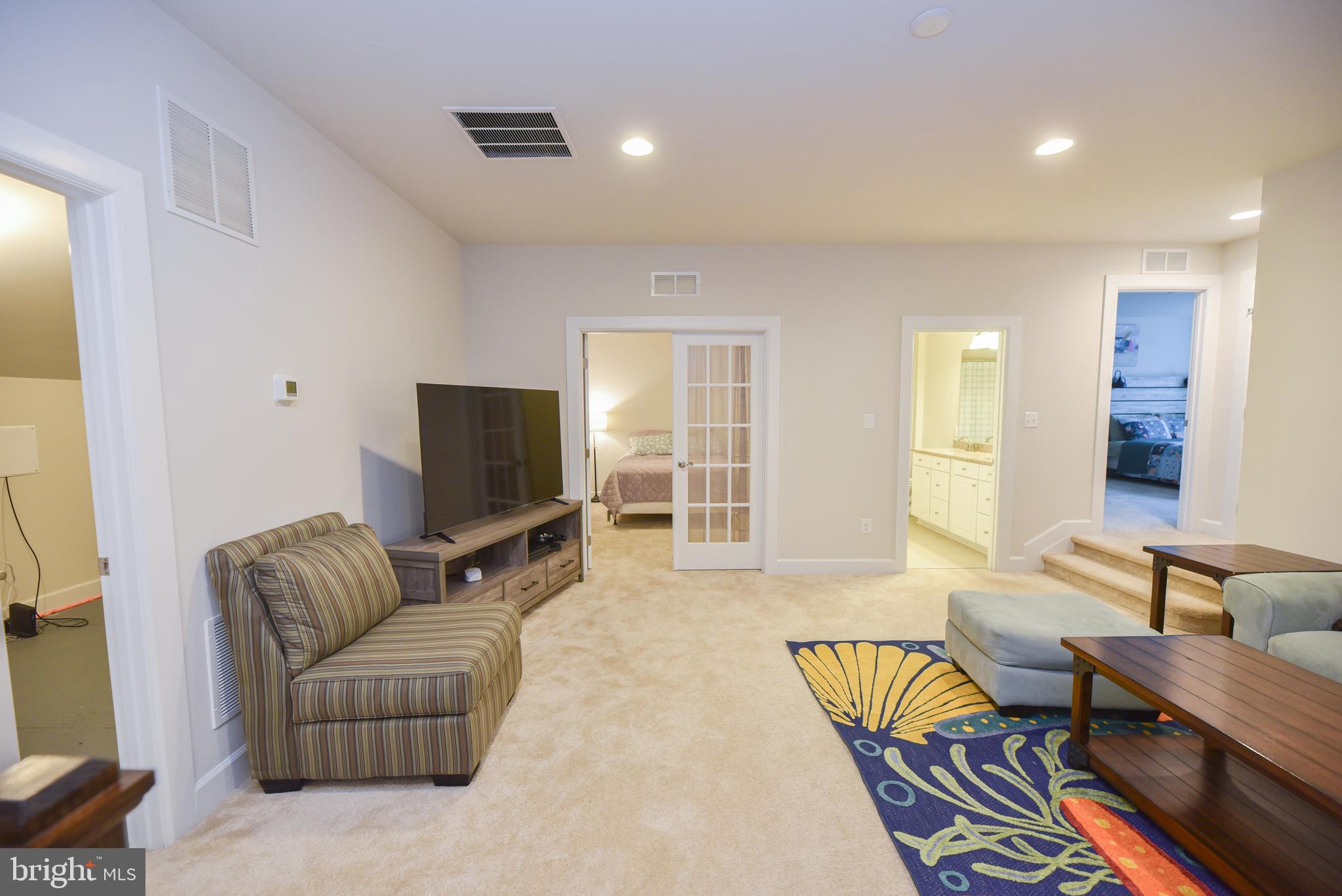 22379 Grebe Lane Ocean View, DE 19970 - Photo 26 of 41 a living room with furniture and a flat screen tv