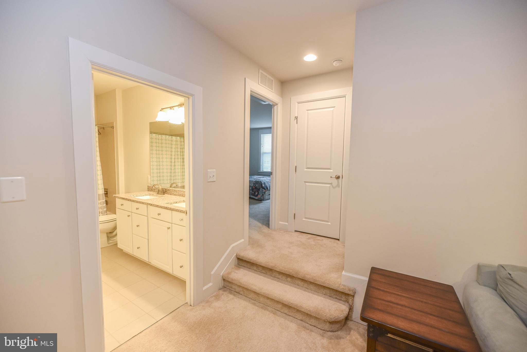 22379 Grebe Lane Ocean View, DE 19970 - Photo 27 of 41 a spacious bathroom with a granite countertop sink and a mirror