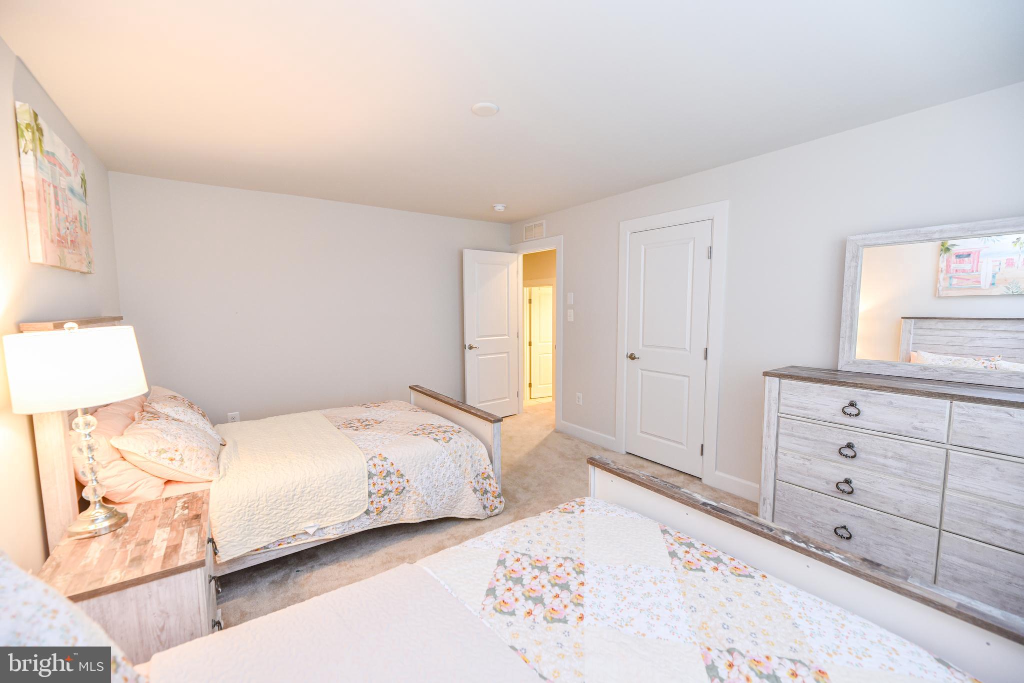 22379 Grebe Lane Ocean View, DE 19970 - Photo 29 of 41 a bedroom with a bed and a dresser