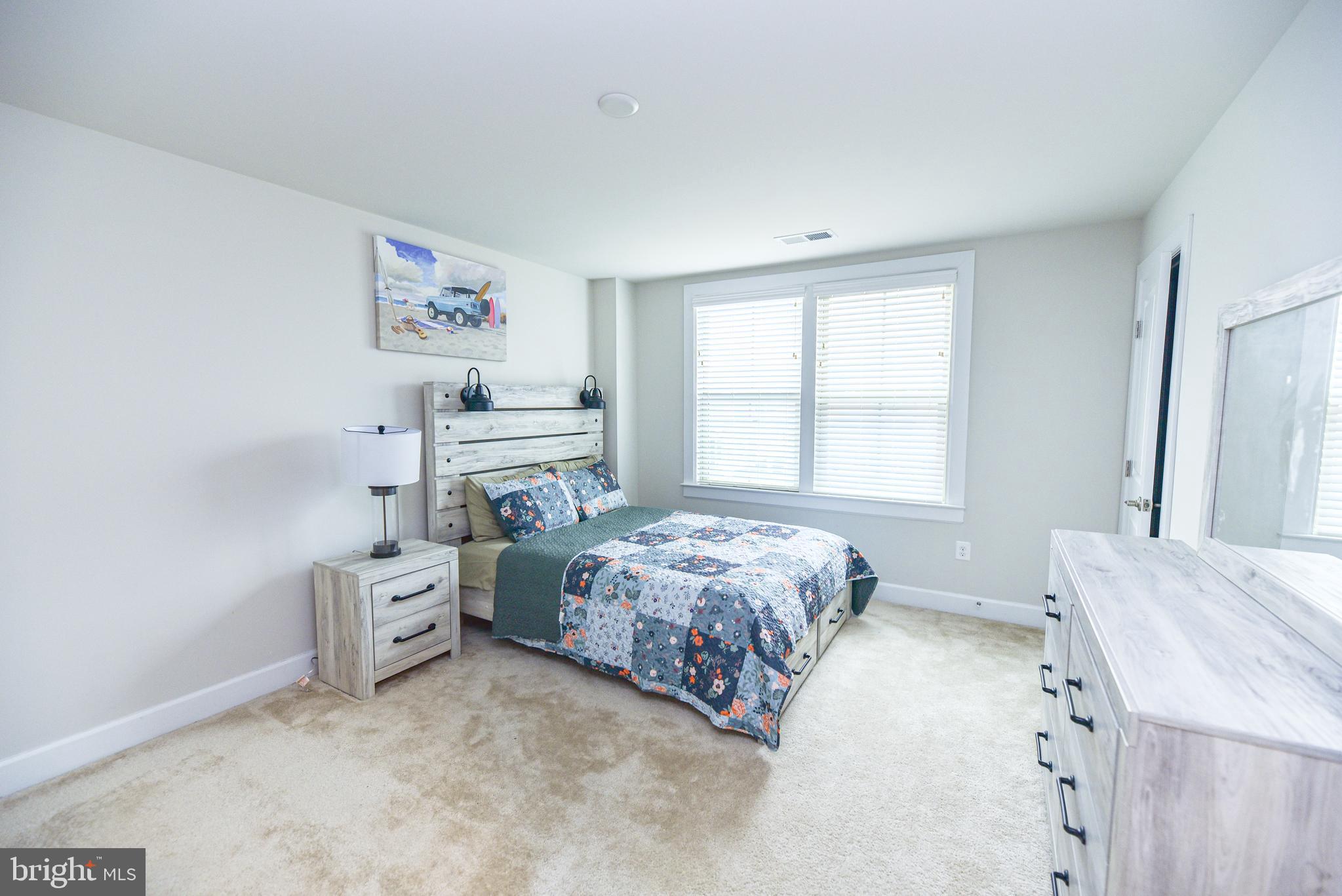 22379 Grebe Lane Ocean View, DE 19970 - Photo 30 of 41 a bedroom with a bed and a window