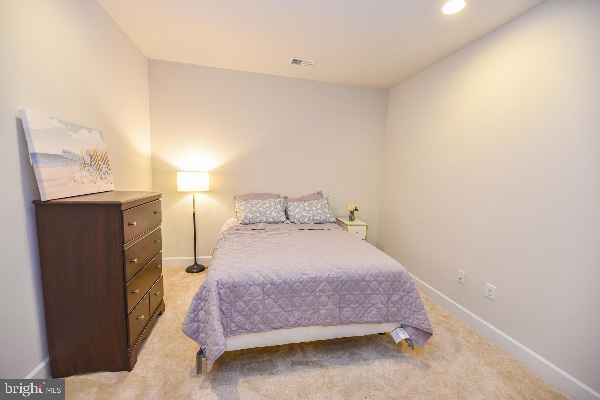 22379 Grebe Lane Ocean View, DE 19970 - Photo 32 of 41 a bedroom with a bed and a night stand