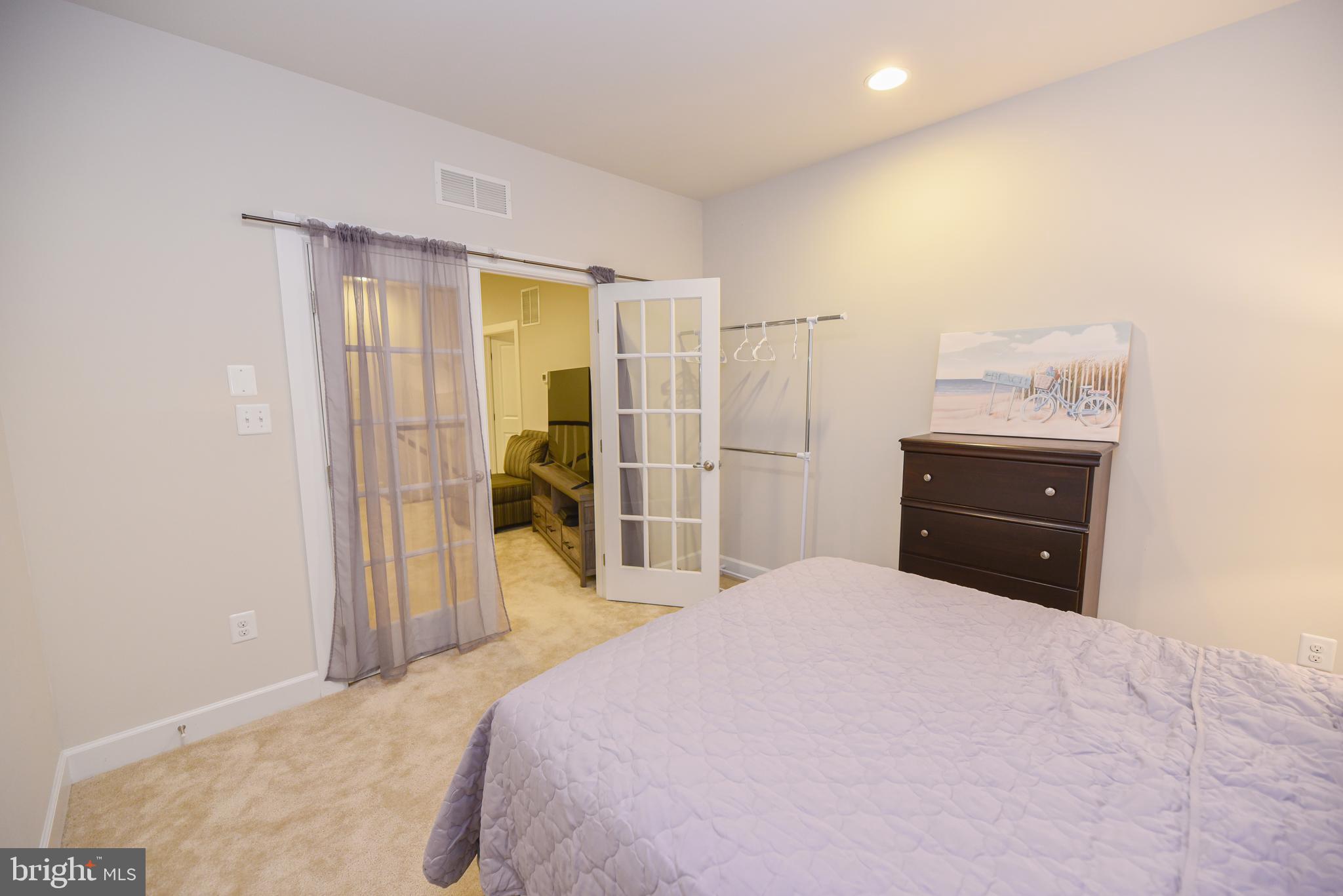 22379 Grebe Lane Ocean View, DE 19970 - Photo 33 of 41 a bedroom with a bed and a dresser