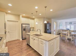 22379 Grebe Lane Ocean View, DE 19970 - Photo 4 of 41 a kitchen with stainless steel appliances granite countertop a sink and a refrigerator