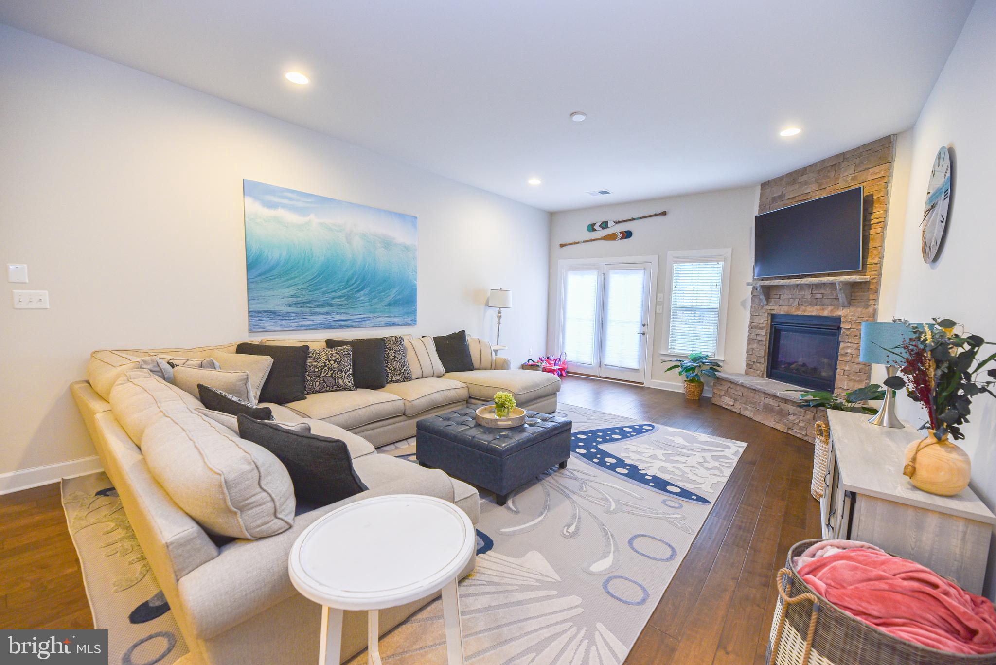 22379 Grebe Lane Ocean View, DE 19970 - Photo 7 of 41 a living room with furniture and a flat screen tv