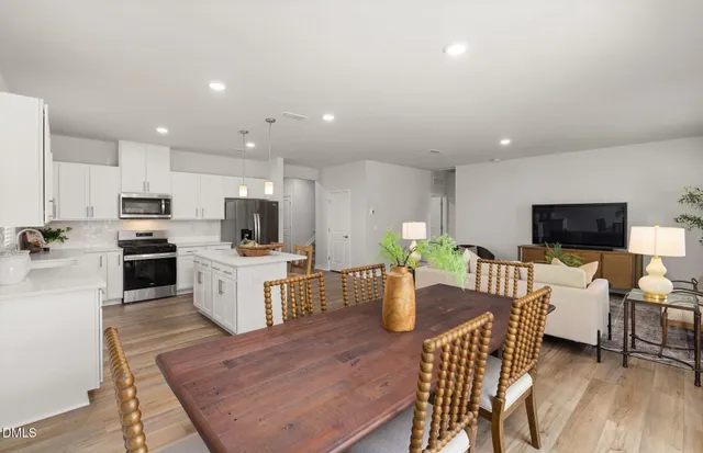 a kitchen with refrigerator cabinets and wooden floor