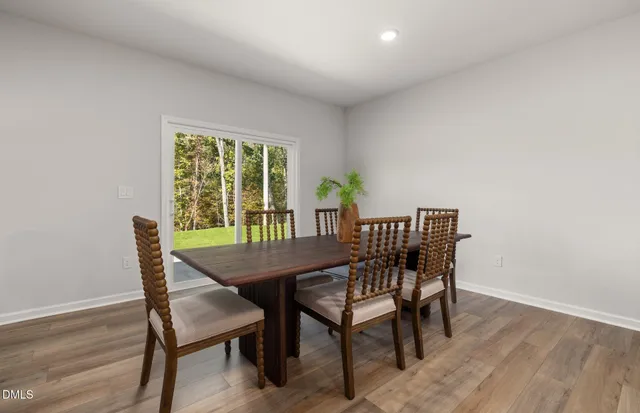 a living room with furniture a flat screen tv and a refrigerator