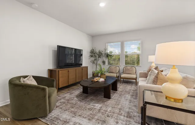 a dining room with furniture and wooden floor