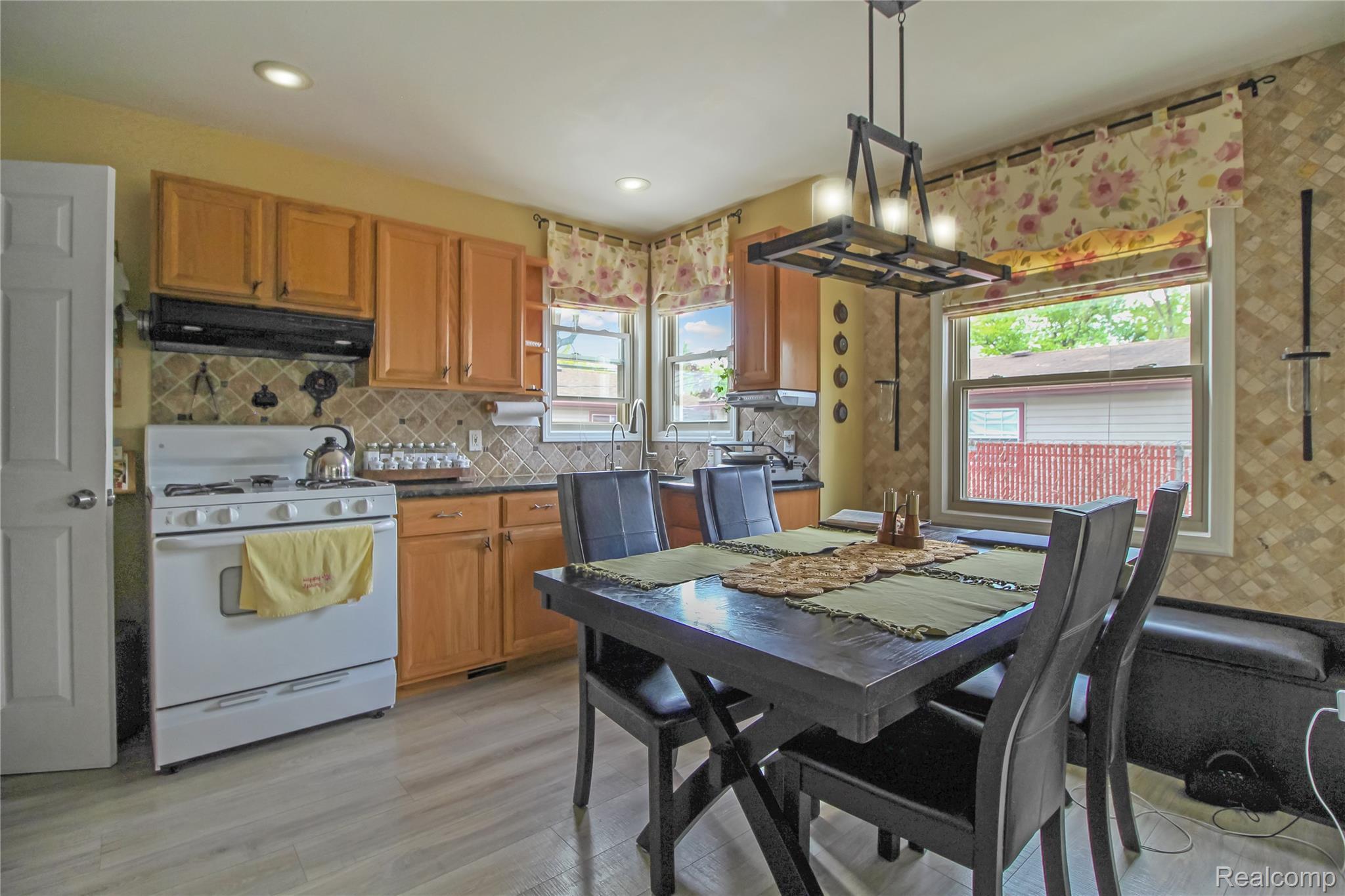 5953 Cooper Street Taylor, MI 48180 - Photo 14 of 33 Kitchen featuring light wood cabinetry, stone-look tile backsplash, recessed lighting, and wood-finish flooring